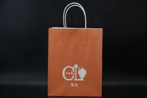 China Custom Orange Eco Paper Bags With Handles Twisted Solid Plate Printing wholesale