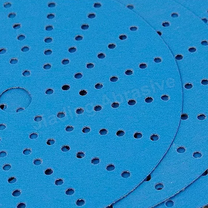 Close-up view of aluminum oxide abrasive surface on sandpaper disc